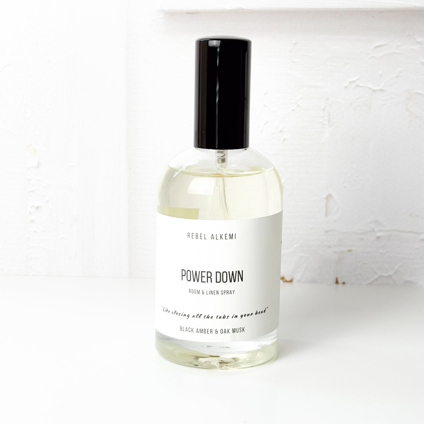 Bottle of Rebel Alkemi 'Power Down' room and linen spray on a white background