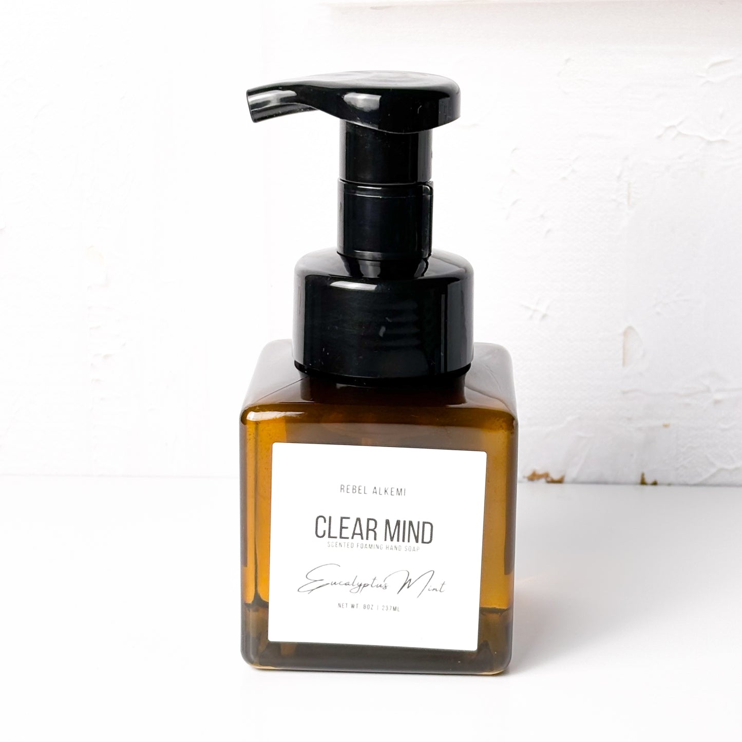 Bottle of 'Clear Mind' with a black pump on a white background