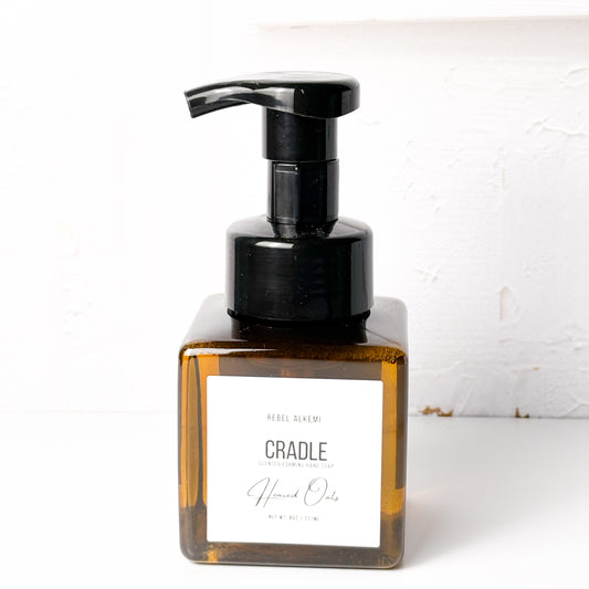 Bottle of 'Cradle' by Rebel Alchemy with a pump on a white background