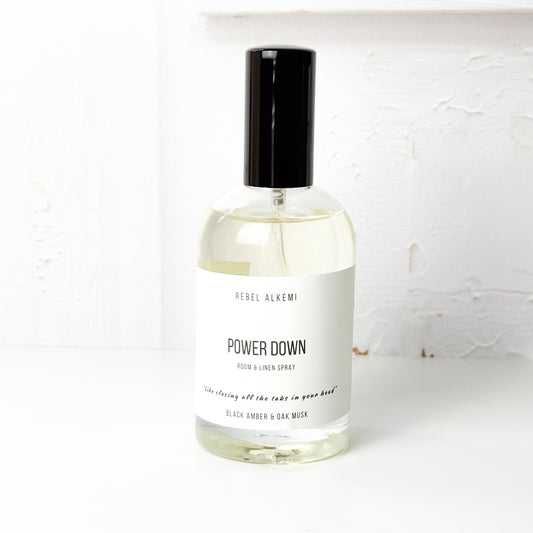 Bottle of Rebel Alkemi 'Power Down' room and linen spray on a white background