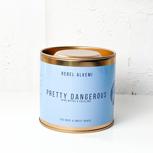 Candle tin labeled 'Pretty Dangerous' by Rebel Alkemi on a white background
