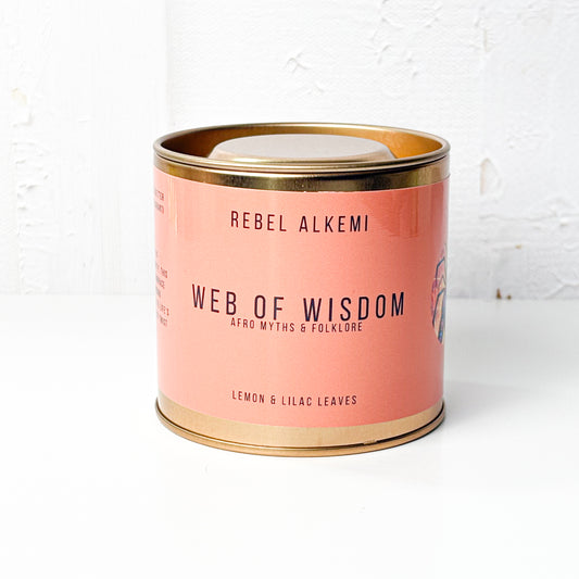 Candle in a copper container with copper lid on a white background, featuring 'Rebel Alkemi' branding.