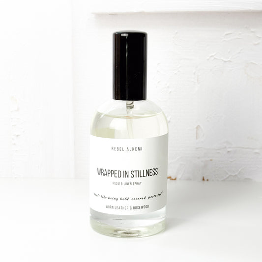 Bottle of Rebel Alkemi 'Wrapped in Stillness' room and linen spray on a white background